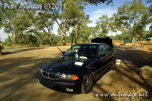 A break from the endless highway to clean the splattered bugs off the windscreen and to top up the fuel from a jerry can. Driving into the sun from here and so a cleen screen makes a huge difference. Photo copyright Peter Andrews, Outimage Australia.
