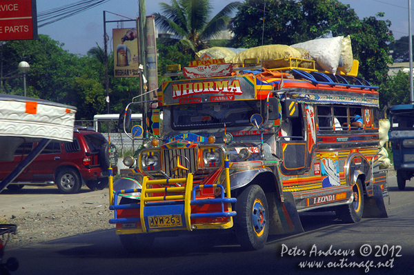 A colourful jeepney on the highway to Kidapawan City, Cotabato Province, Mindanao, Philippines. Photo copyright Peter Andrews, Outimage Australia.