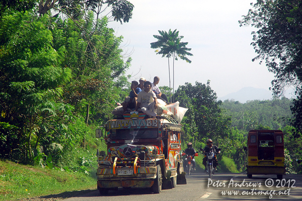 A double-decker jeepney beyond Kidapawan City, Cotabato Province, Mindanao, Philippines. Photo copyright Peter Andrews, Outimage Australia.