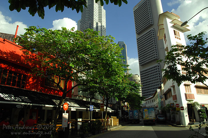 Below the OCBC Centre building that was built in 1976, the restaurants and small bars along Circular Road at Boat Quay in Singapore prepare for another busy evening of trade. Photo © Peter Andrews / Outimage. Walking from Circular Road to Chinatown in Singapore as the city prepares for the Lunar New Year.