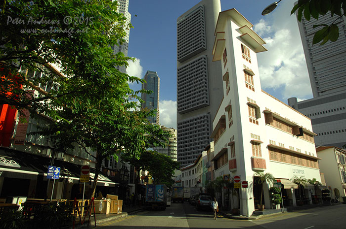 Built in 1938 by Singapore's first local architect Ho Kwong Yew (who was unfortunately executed by the Japanese Army during the occupation of World War 2) is the iconic Expressionist and Art Deco shophouse on the corner of Circular Road and Lorong Telok. Originally known as the Tai Chung Building and used as office space, it recently housed a micro-brewery. Photo © Peter Andrews / Outimage. Walking from Circular Road to Chinatown in Singapore as the city prepares for the Lunar New Year.