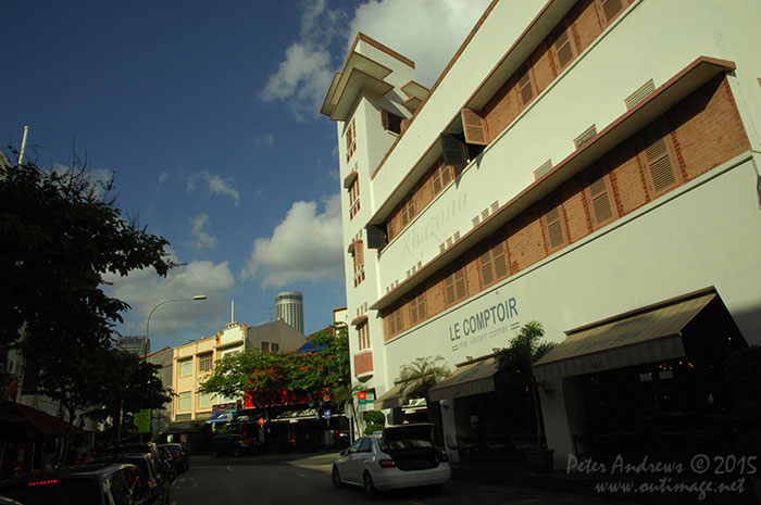 Built in 1938 by Singapore's first local architect Ho Kwong Yew (who was unfortunately executed by the Japanese Army during the occupation of World War 2) is the iconic Expressionist and Art Deco shophouse on the corner of Circular Road and Lorong Telok. Originally known as the Tai Chung Building and used as office space, it recently housed a micro-brewery. Photo © Peter Andrews / Outimage. Walking from Circular Road to Chinatown in Singapore as the city prepares for the Lunar New Year.