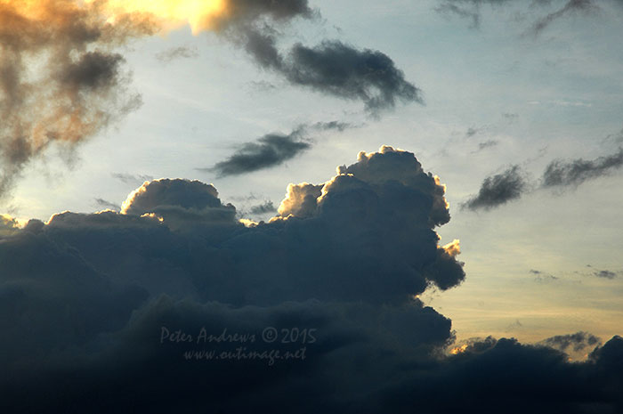 Evening storm clouds building up over the mountains surrounding Davao City, Mindanao, seen from Paradise Island Beach on Samal Island.