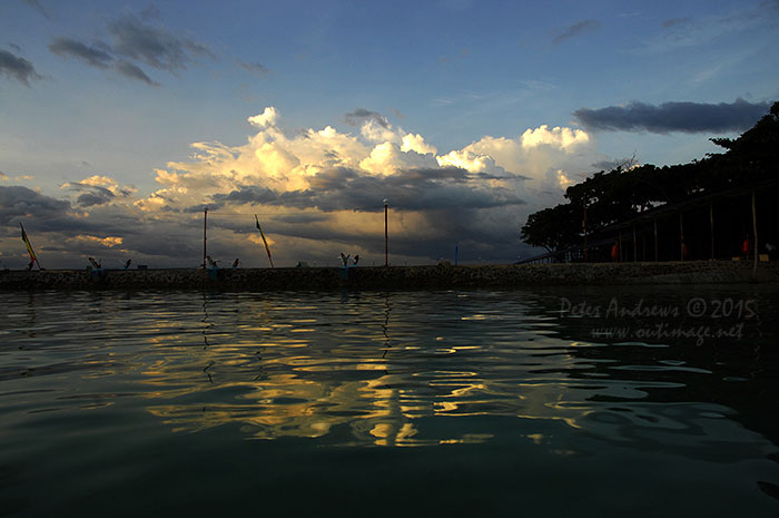 Evening storm clouds building up over the mountains surrounding Davao City, Mindanao, seen from Paradise Island Beach on Samal Island.