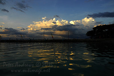 Evening storm clouds building up over the mountains surrounding Davao City, Mindanao, seen from Paradise Island Beach on Samal Island.