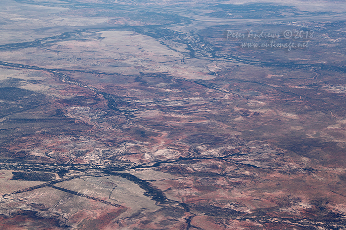 The shallow valleys of the Landsborough, Towerhill and Cornish Creeks all flow into the Thompson River just north of Muttaburra, Outback Queensland. The view from: 22°08'05.3"S 144°58'03.3"E. High altitude shots from a flight between Sydney Australia and Manila, Philippines.