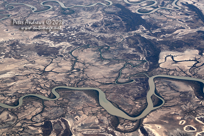 The Bynoe and Flinders Rivers wind their way through tidal mudflats towards the Gulf of Carpentaria, near Normanton in outback Queensland. 17°35'44.4"S 140°44'31.6"E. High altitude shots from a flight between Sydney Australia and Manila, Philippines.