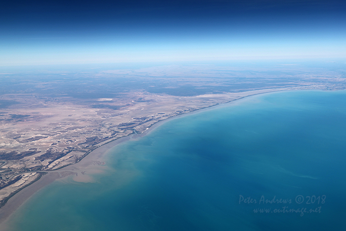 Looking across the tidal mudflats towards the Queensland town of Burketown with the Flinders River flowing into the Gulf of Carpentaria, near Normanton in outback Queensland. 17°17'10.1"S 140°32'02.8"E. High altitude shots from a flight between Sydney Australia and Manila, Philippines.