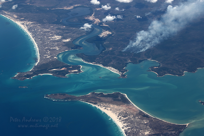 Fire stick burning, a traditional indigenous fire management practice seen on the coastline of East Arnhem Land and home of the Yolngu People near Nhulunbuy in the Northern Territory. 12°34'33.6"S 136°49'42.0"E. High altitude shots from a flight between Sydney Australia and Manila, Philippines.