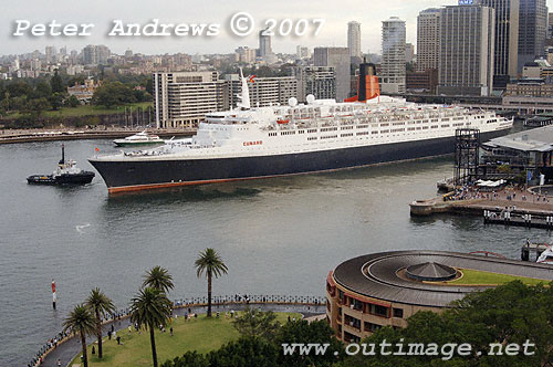 QE2 departing Circular Quay with the Sydney skyline in the background.