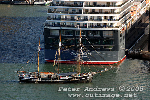 The tallship Svanen dwarfed by the stern of the Queen Victoria at the Overseas Passenger Terminal at Circular Quay.