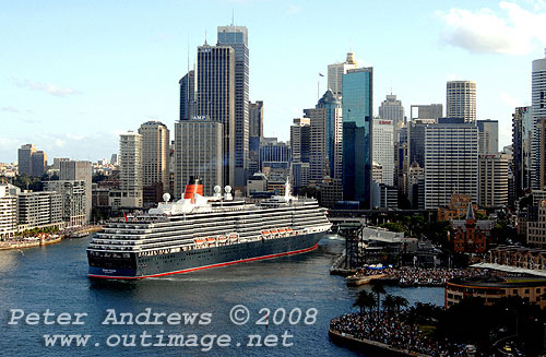 Queen Victoria easily slips astern out of Circular Quay with no assistance from tugs with the Sydney city skyline in the background.