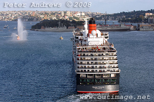 Queen Victoria being led out of Sydney Harbour by the fire tug Ted Noffs.