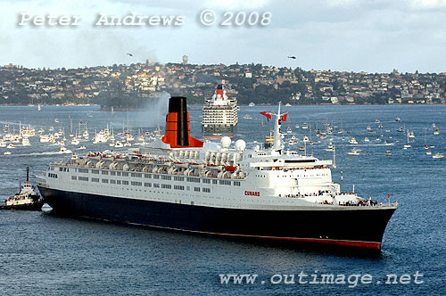 Queen Elizabeth II steaming to Circular Quay with Queen Victoria in the background leaving Sydney Harbour.