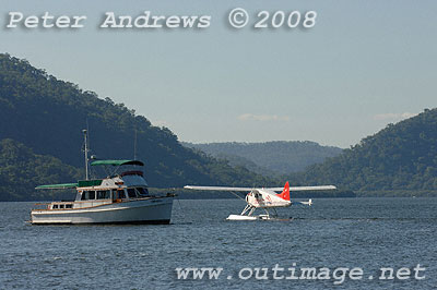 Pacific Lady, a 1978 42 Heritage CL at anchor off Peat's Bite with a visiting seaplane.