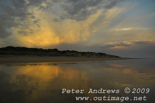 Illawarra's Corrimal Beach at sunset looking towards Bellambi Point and a storm cell passing over Sydney to the north. Photo copyright Peter Andrews, Outimage.