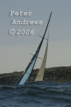 Skandia hiding behind a South Pacific rolling swell sailing past North Head after the start of the 2006 Rolex Sydney Hobart Yacht Race.