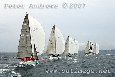 A line of Farr 40's under spinnaker running down to the bottom of the course. The sea surface starting to appear a little choppy from an increase in breeze.