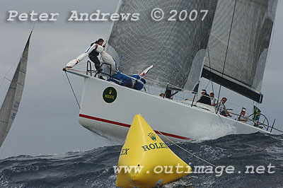 Roger Sturgeon's Transpac 65 Rosebud from the United States, leaping off the top of a large wave at the top mark.