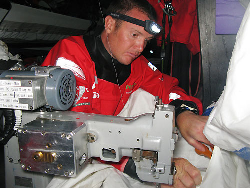 Phil Harmer repairing the A6 sail below decks, on leg 2 of the Volvo Ocean Race, from Cape Town, South Africa to Cochin, India. Photo © Guo Chuan / Green Dragon Racing / Volvo Ocean Race.