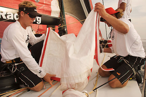 Casey Smith and Michael Muller pack sails onboard il mostro, at the start of leg 3 of the Volvo Ocean Race.