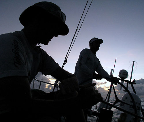 Pepe Ribes at the helm while Tom Addis checks the time for the next weather download, onboard Telefonica Blue, on leg 3 of the Volvo Ocean Race from India to Singapore. Photo copyright Gabriele Olivo / Telefonica Blue / Volvo Ocean Race.