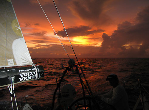 Rodion Luka steering the wheel at sunset, onboard Team Russia, on leg 3 of the Volvo Ocean Race from India to Singapore. Photo copyright Sergey Bogdanov / Team Russia / Volvo Ocean Race.