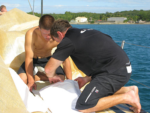 Team Delta Lloyd earlier in Leg 4 taking shelter in Salomique Bay, Philippines. The Crew is seen working hard to repair the ripped mainsail on deck. Photo copyright Sander Pluijm / Team Delta Lloyd / Volvo Ocean Race.