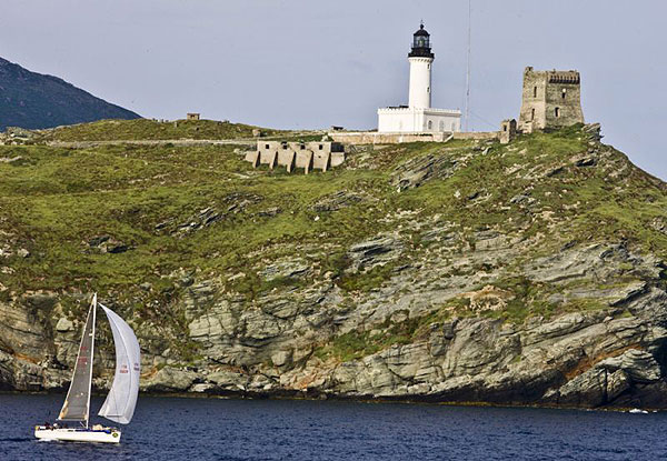 Marco Paolucci's Tartaruga sails past Giraglia Rock.