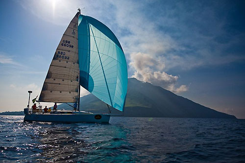 Ken Raby's Squibs (GBR) with Stromboli in the background, during the Rolex Middle Sea Race 2008. Photo copyright ROLEX and Kurt Arrigo.