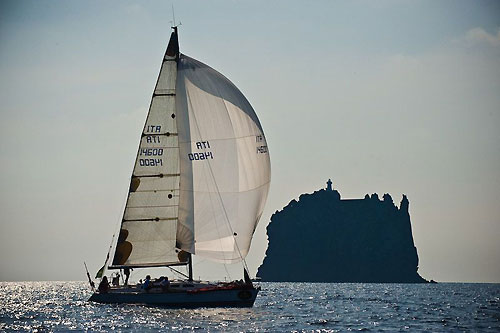 Tommaso Cerulli Irelli's Oxygene (ITA) sailing past Stromboliccio during the Rolex Middle Sea Race 2008. While crossing the Sicilian channel between Favignana and Pantelleria, a violent squall hit the remaining fleet around the middle of the day and Oxygene was the first to report a problem. Being short-handed and unable to start their engine to charge batteries and provide power to their instruments, a decision was made to end their race at Pantelleria to assess their options. Photo copyright ROLEX and Kurt Arrigo.