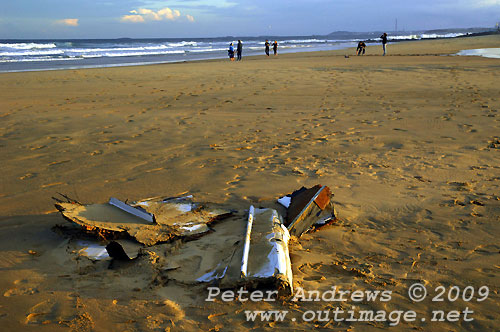 Carbon fibre from Shockwave 5, washed up on Corrimal Beach, NSW Australia with Towradgi Point in the background. Flinders Island is seen on the horizon, just under the sunlit storm clouds. Photo copyright Peter Andrews.