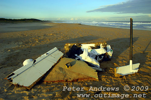 Carbon fibre and other remains from Shockwave 5, stacked by local Surf Lifesavers for collection after washing up on Corrimal Beach, NSW Australia. Photo copyright Peter Andrews.