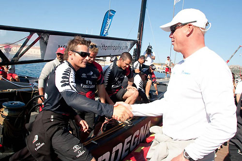 Louis Vuitton Trophy, La Maddalena, Italy, May 22nd-June 6th 2010. Race Day 16. Final: Karol Jablonski greets Dean Barker at his arrival to the pontoon. Photo copyright Bob Grieser, Outsideimages NZ and Louis Vuitton Trophy.