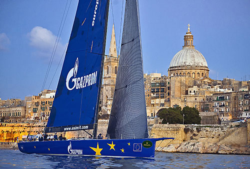 Igor Simcic's Esimit Europa 2, taking out Line Honours - crossing the finish line at 18:32:32 for the 31st Rolex Middle Sea Race. Photo copyright Rolex and Rene Rossignaud.