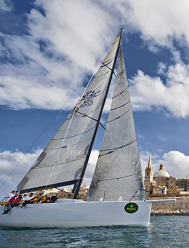 Bryon Ehrhart's TP52 Lucky arrives at the finish, during the 31st Rolex Middle Sea Race. Photo copyright Rolex and Rene Rossignaud.