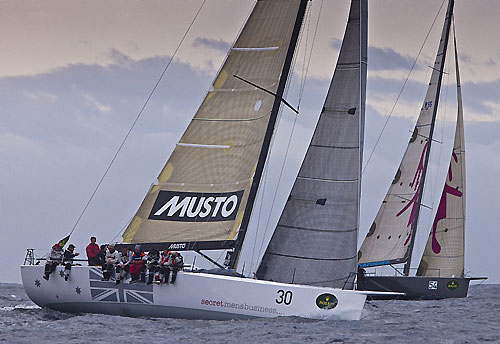 Geoff Boettcher’s South Australian yacht and Handicap Winner, Secret Mens’ Business 3.5 crossing Storm Bay with Michael Hiatt's Farr 55 Living Doll, during the Rolex Sydney Hobart Yacht Race. Photo copyright Rolex and Daniel Forster.