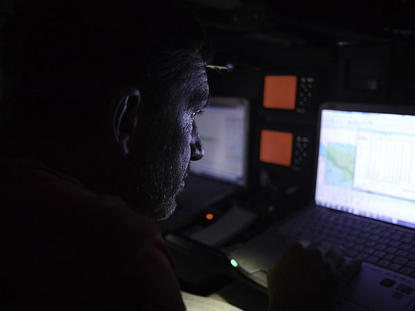 Navigator Will Oxley in the Nav Station onboard CAMPER with Emirates Team New Zealand during leg 1 of the Volvo Ocean Race 2011-12, from Alicante, Spain to Cape Town, South Africa. Photo Hamish Hooper / CAMPER ETNZ / Volvo Ocean Race.