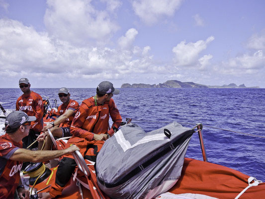 The crew look on at Fernando de Noronha Island onboard CAMPER with Emirates Team New Zealand during, leg 1 of the Volvo Ocean Race 2011-12, from Alicante, Spain to Cape Town, South Africa. Photo Hamish Hooper / CAMPER ETNZ / Volvo Ocean Race.