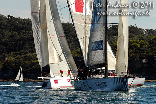 Anthony Bell's 100 ft maxi Investec Loyal and Bob Oatley's Reichel Pugh 100 Wild Oats XI tacking duel out of Sydney Harbour, after the start of the Audi Sydney Gold Coast 2011. Photo copyright Peter Andrews, Outimage Australia.