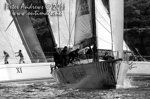 Anthony Bell's 100 ft maxi Investec Loyal and Bob Oatley's Reichel Pugh 100 Wild Oats XI tacking duel out of Sydney Harbour, after the start of the Audi Sydney Gold Coast 2011. Photo copyright Peter Andrews, Outimage Australia.