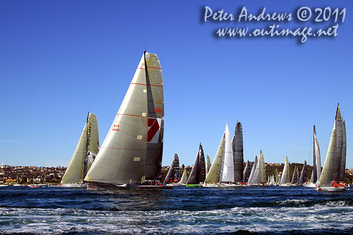 Anthony Bell's 100 ft maxi Investec Loyal and Bob Oatley's Reichel Pugh 100 Wild Oats XI tacking duel out of Sydney Harbour, after the start of the Audi Sydney Gold Coast 2011. Photo copyright Peter Andrews, Outimage Australia.