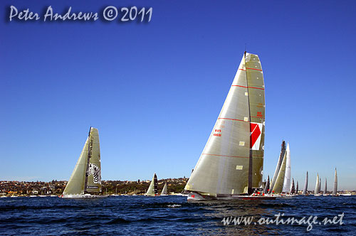 Anthony Bell's 100 ft maxi Investec Loyal and Bob Oatley's Reichel Pugh 100 Wild Oats XI tacking duel out of Sydney Harbour, after the start of the Audi Sydney Gold Coast 2011. Photo copyright Peter Andrews, Outimage Australia.