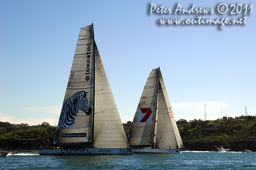 Anthony Bell's 100 ft maxi Investec Loyal and Bob Oatley's Reichel Pugh 100 Wild Oats XI tacking duel out of Sydney Harbour, after the start of the Audi Sydney Gold Coast 2011. Photo copyright Peter Andrews, Outimage Australia.