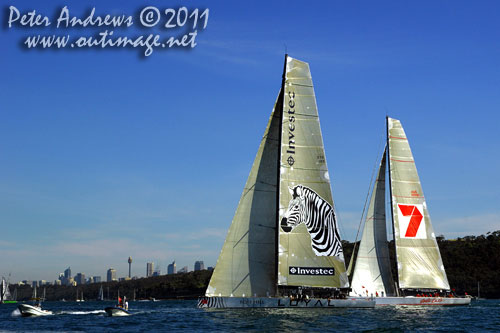 Anthony Bell's 100 ft maxi Investec Loyal and Bob Oatley's Reichel Pugh 100 Wild Oats XI tacking duel out of Sydney Harbour, after the start of the Audi Sydney Gold Coast 2011. Photo copyright Peter Andrews, Outimage Australia.