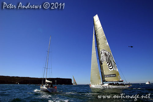 Anthony Bell's 100 ft maxi Investec Loyal and Bob Oatley's Reichel Pugh 100 Wild Oats XI tacking duel out of Sydney Harbour, after the start of the Audi Sydney Gold Coast 2011. Photo copyright Peter Andrews, Outimage Australia.