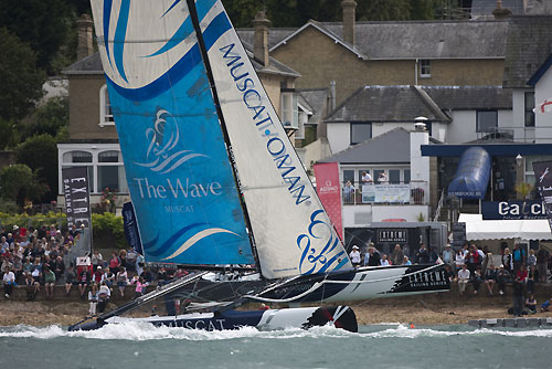 The Wave-Muscat in flight in front of the Race Village on the Day 1 of Act 5 of the Extreme Sailing Series 2011, Cowes, United Kingdom. Photo copyright Lloyd Images