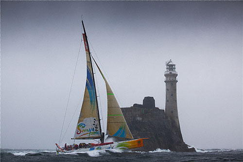 Mike Sanderson's Team Sanya rounding Fastnet Rock, during the Rolex Fastnet Race 2011. Photo copyright Rolex and Daniel Forster.