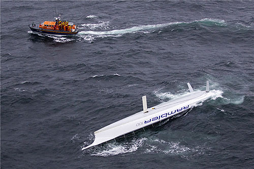 George David's Rambler 100 capsized and the crew being rescued by the Baltimore RNLI lifeboat, during the Rolex Fastnet Race 2011. Photo copyright Rolex and Carlo Borlenghi.