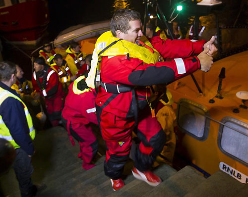 Rambler 100's crew arriving back on shore at Baltimore after their rescue from a capsize, during the Rolex Fastnet Race 2011. Photo copyright Rolex and Carlo Borlenghi.